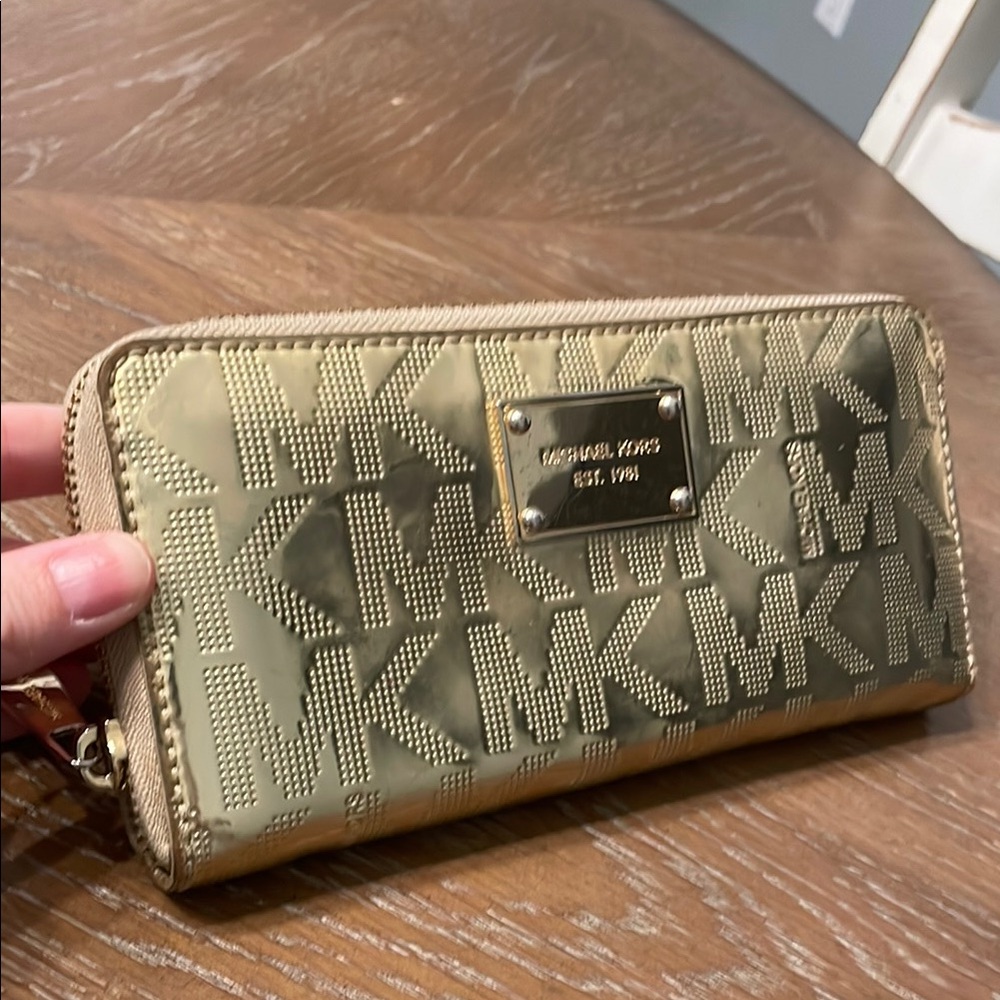 Used Michael Kors metallic patent leather monogram gold zip wallet